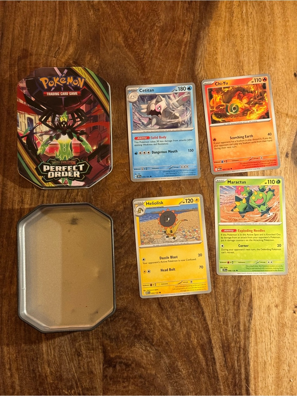 Can of Pokémon cards and 4 cards over a 100 hp